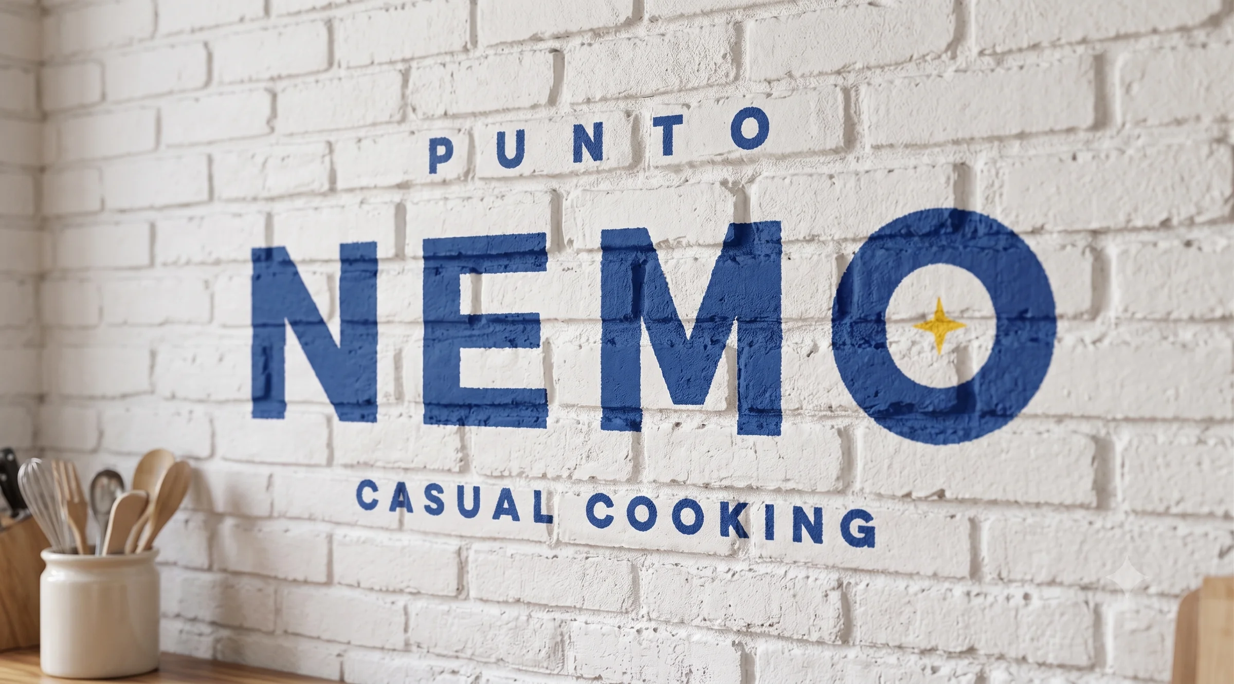 Logotipo Punto Nemo pintado sobre pared de ladrillo en cocina